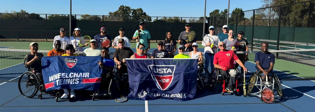 Wheelchair tennis players and volunteers with banners on a court