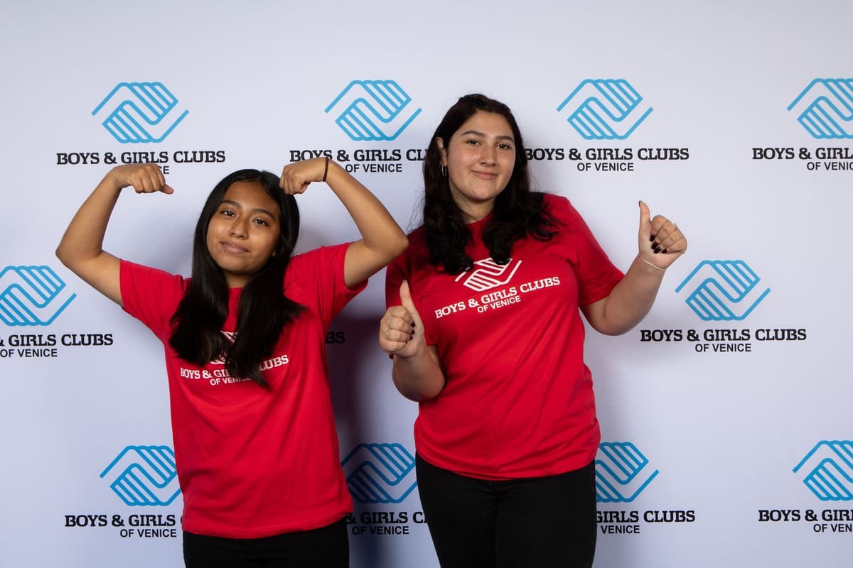 Two club members in red club T-shirts