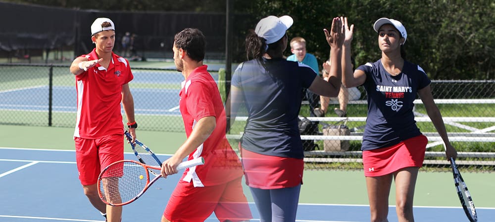 Saint Mary's College tennis players high-fiving on court