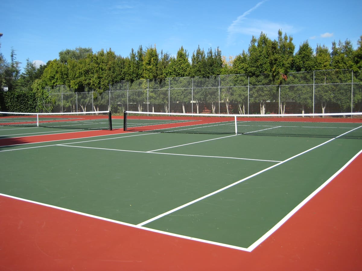 Empty tennis court with green and red surface