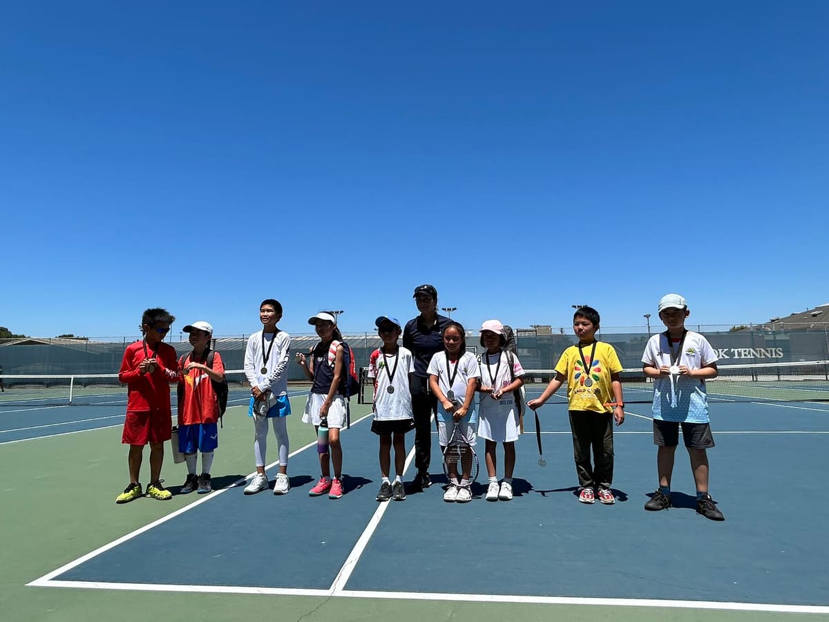 Young players and coaches posing on a court